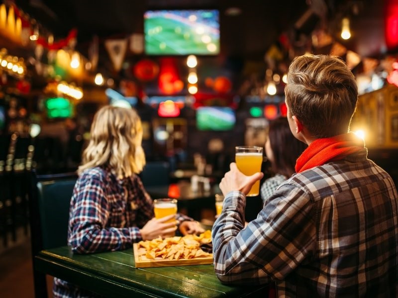 fans-watching-match-and-drinks-beer-in-sports-bar-2021-08-26-16-26-56-utc-min.jpg