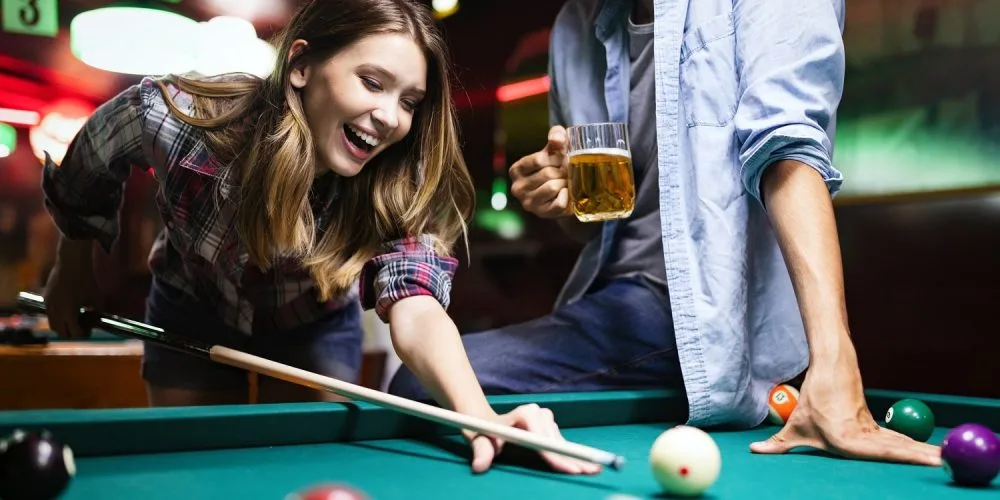 Couple Having Fun Playing Billiard